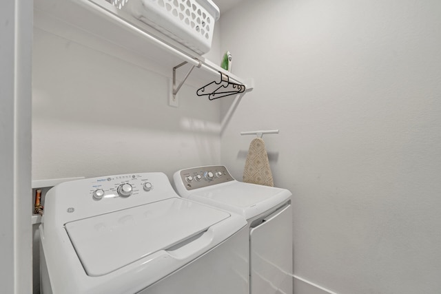 laundry area featuring washing machine and clothes dryer