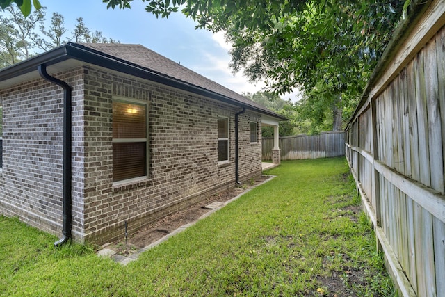 view of home's exterior with a yard