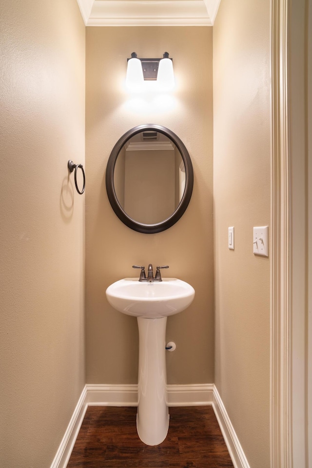 bathroom featuring crown molding and wood-type flooring