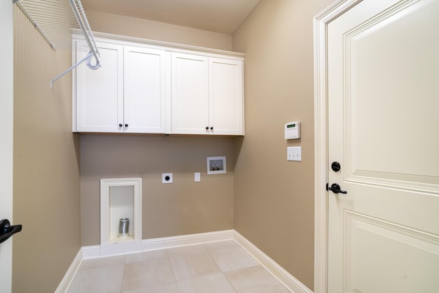 washroom featuring hookup for an electric dryer, cabinets, washer hookup, and light tile patterned flooring