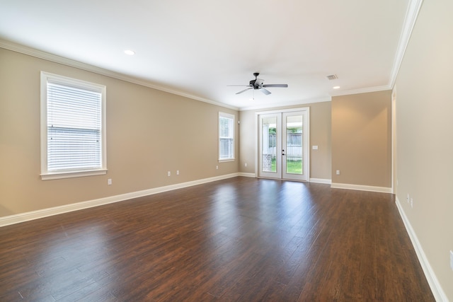 empty room with ceiling fan, dark hardwood / wood-style floors, crown molding, and french doors