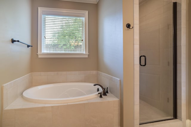 bathroom featuring shower with separate bathtub