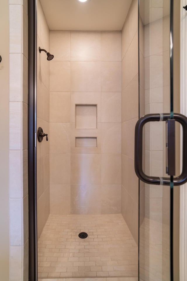 bathroom with a shower with shower door