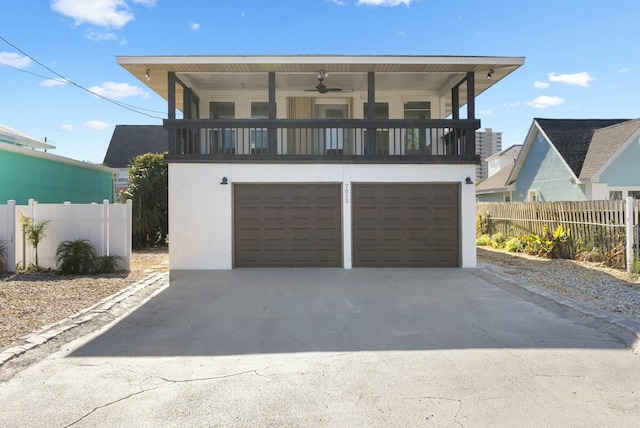 view of front of property featuring ceiling fan and a garage