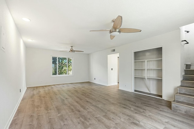 unfurnished living room with built in features, ceiling fan, and light hardwood / wood-style flooring