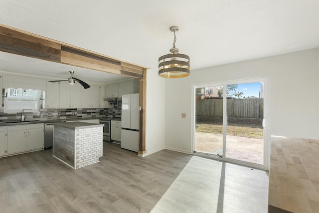 kitchen with sink, white refrigerator, white cabinets, electric stove, and decorative backsplash