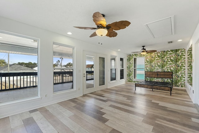 unfurnished sunroom featuring ceiling fan