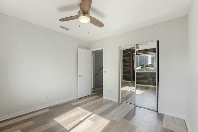 unfurnished bedroom featuring a closet, ceiling fan, and light hardwood / wood-style flooring