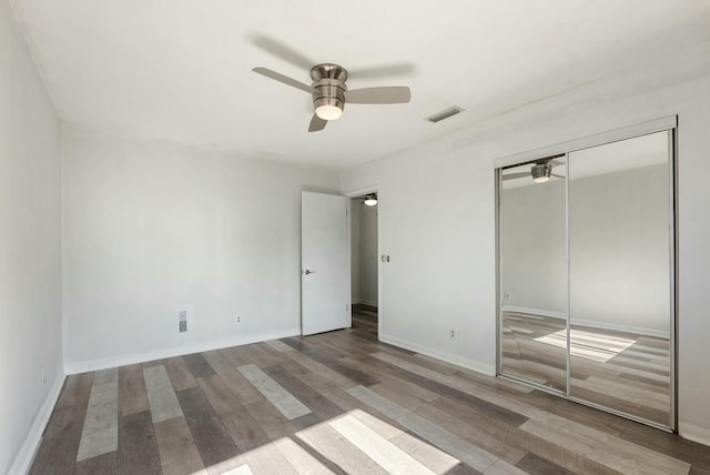 unfurnished bedroom featuring a closet, ceiling fan, and hardwood / wood-style flooring