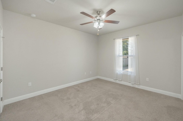 carpeted spare room with ceiling fan