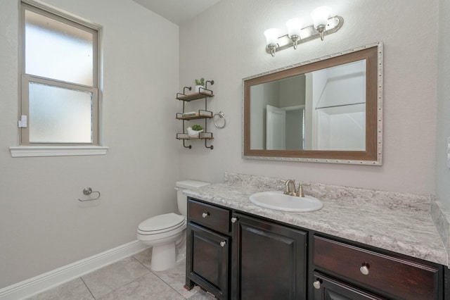 bathroom featuring tile patterned flooring, vanity, and toilet