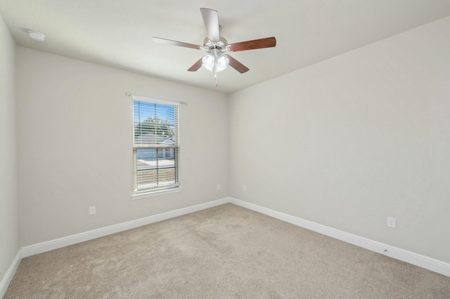 unfurnished room featuring light carpet and ceiling fan