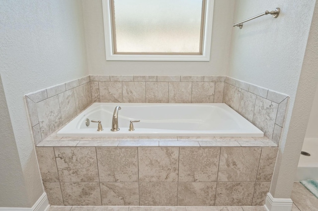 bathroom featuring a relaxing tiled tub