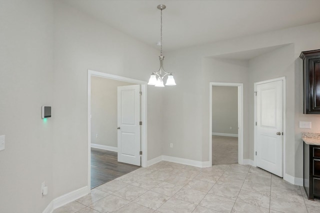 unfurnished dining area with a notable chandelier