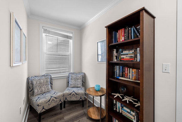 sitting room with crown molding, wood-type flooring, and a healthy amount of sunlight