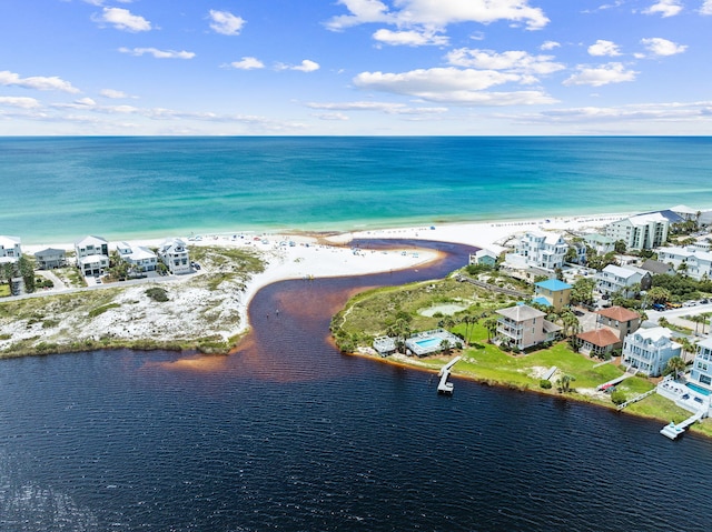 bird's eye view featuring a water view and a beach view