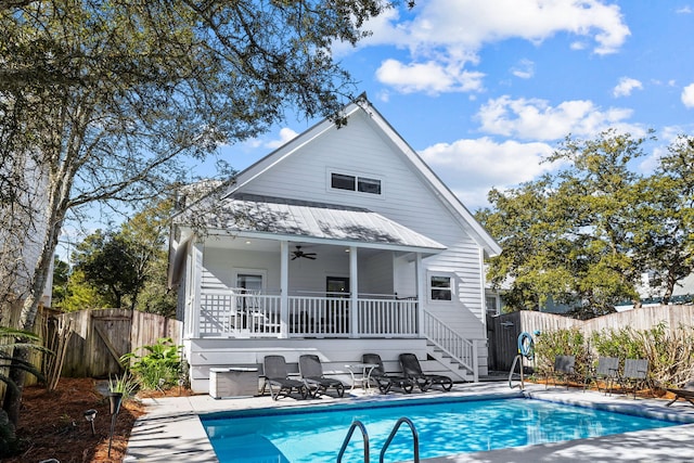 rear view of house featuring a fenced in pool, a patio area, and ceiling fan