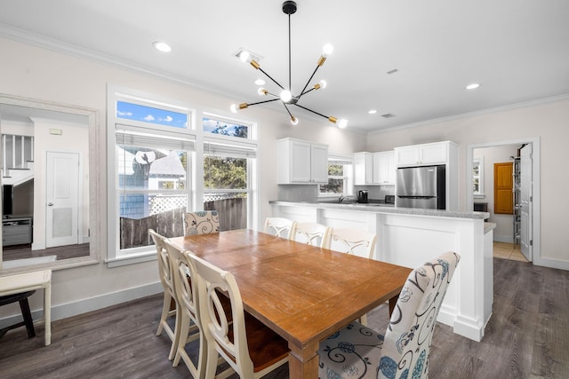 dining area with crown molding, dark hardwood / wood-style flooring, and a chandelier