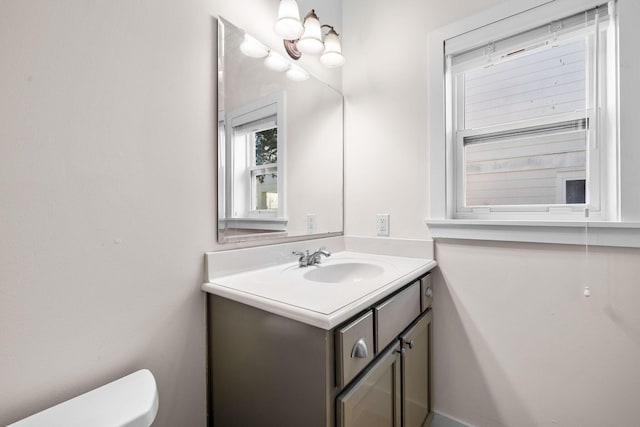 bathroom featuring vanity and toilet