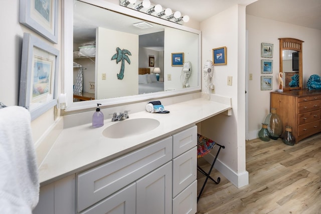 bathroom with vanity and wood-type flooring