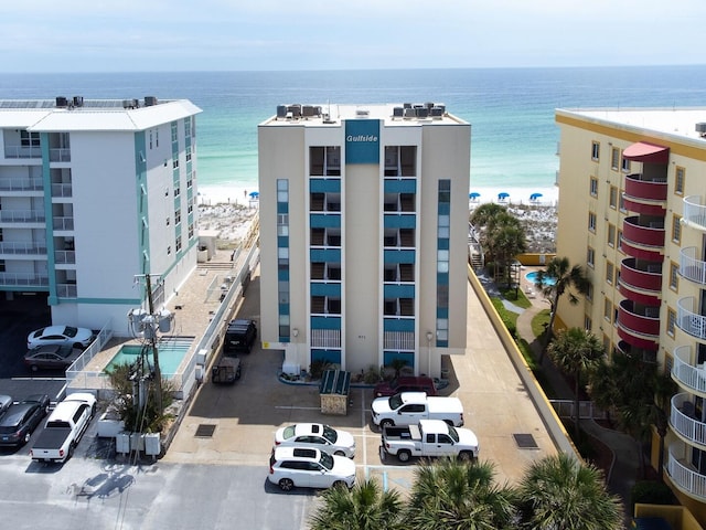 view of property with a view of the beach and a water view