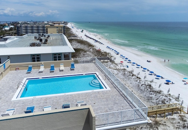 drone / aerial view with a beach view and a water view