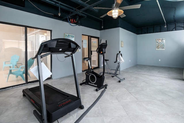 workout area featuring ceiling fan and a high ceiling