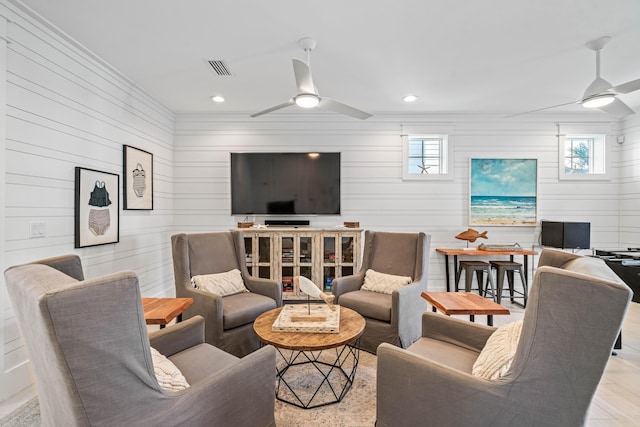 living room with ceiling fan and plenty of natural light