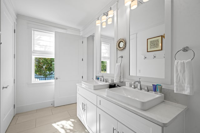 bathroom with ornamental molding, tile patterned floors, and vanity