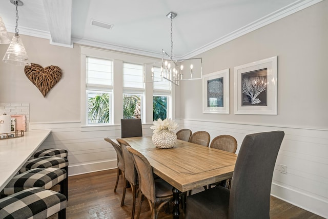 dining space with beam ceiling, ornamental molding, and dark wood-type flooring