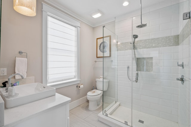 bathroom with sink, toilet, ornamental molding, and plenty of natural light