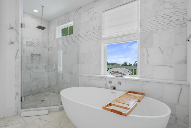 bathroom with independent shower and bath and tile walls