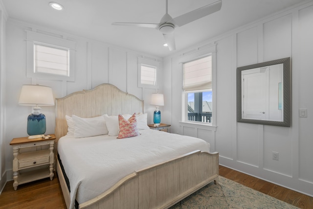 bedroom with ceiling fan and dark hardwood / wood-style floors