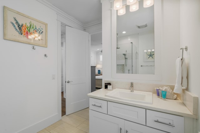 bathroom featuring crown molding, a shower with shower door, and vanity