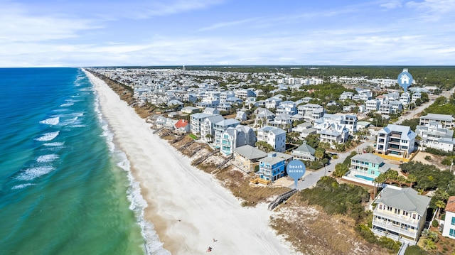 birds eye view of property featuring a water view and a view of the beach