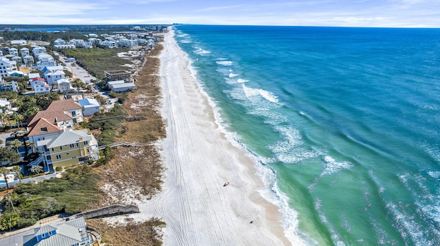 drone / aerial view featuring a water view and a beach view