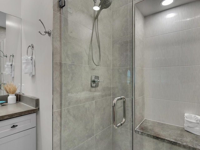 bathroom featuring walk in shower and vanity