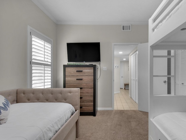 carpeted bedroom with multiple windows, crown molding, and a closet