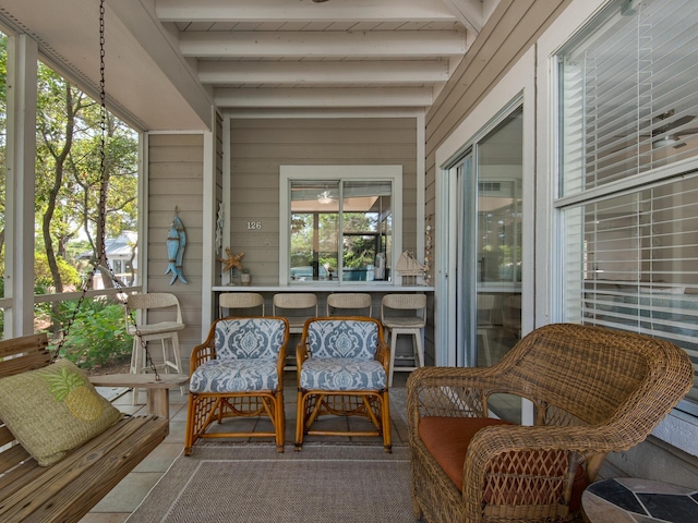 sunroom featuring beamed ceiling