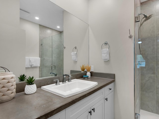 bathroom with vanity and a shower with shower door