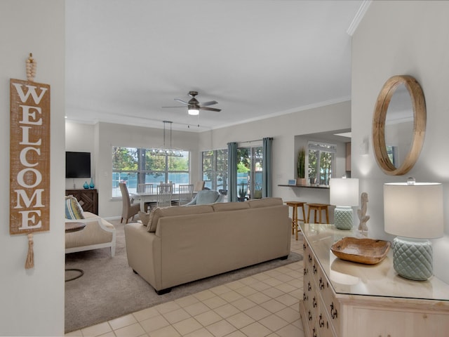 tiled living room with crown molding and ceiling fan