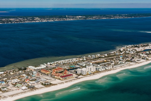 birds eye view of property with a water view and a view of the beach