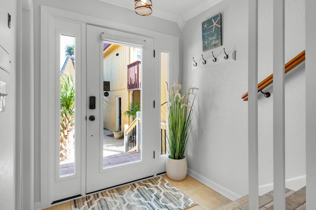 entryway with light tile patterned flooring and ornamental molding