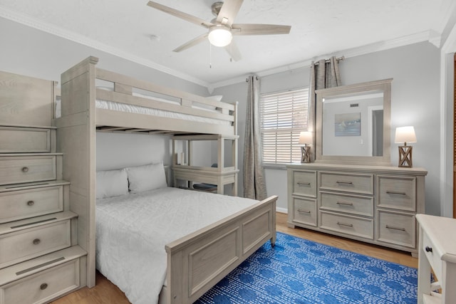 bedroom featuring dark wood-type flooring, ornamental molding, and ceiling fan