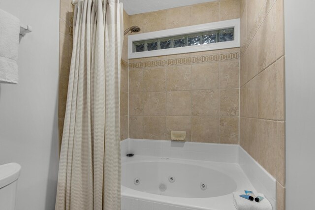 bathroom with shower / bath combo and toilet