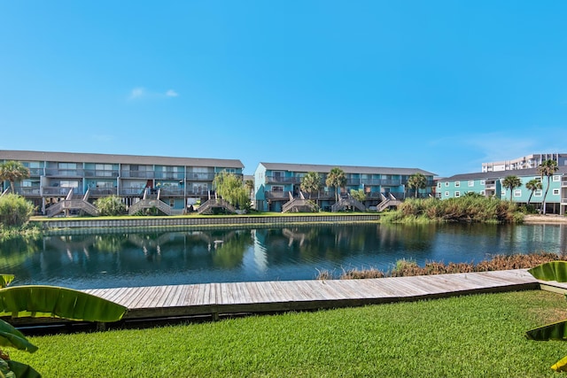 view of property's community featuring a yard and a water view