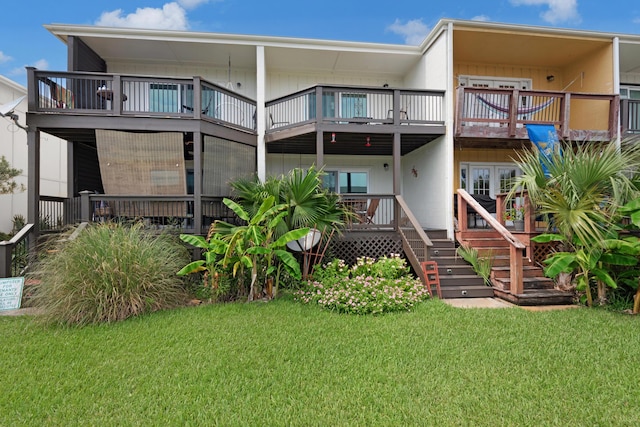 rear view of property featuring a lawn