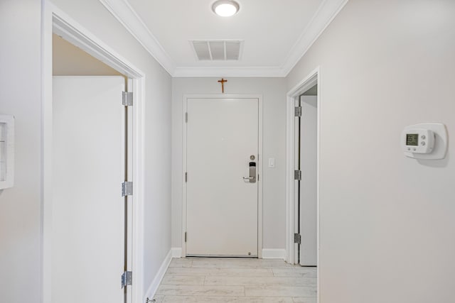 doorway to outside featuring crown molding and light hardwood / wood-style floors