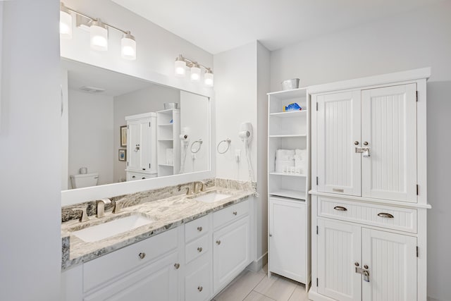 bathroom with vanity and toilet