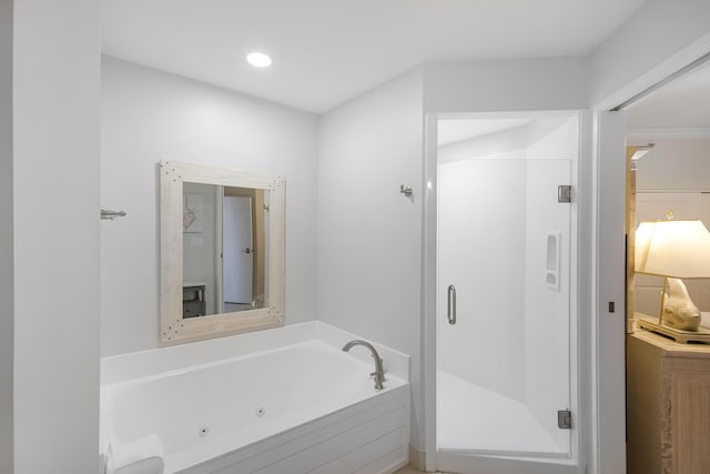 bathroom featuring independent shower and bath